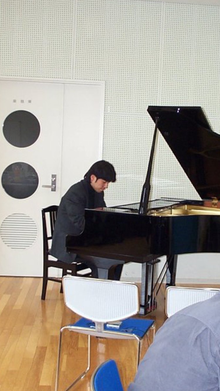 January M Itzki playing a grand piano
